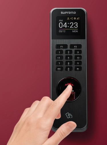 Person scanning fingerprint on Suprema biometric BioLite N2 reader for secure access authentication