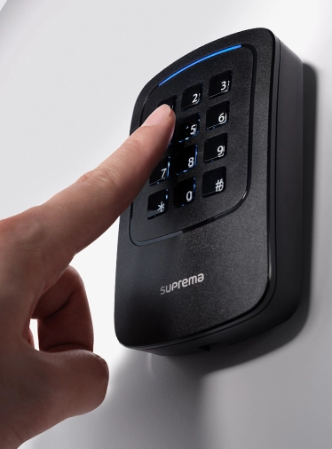 User entering access code on Suprema Xpass 2 Gangbox keypad for secure door entry