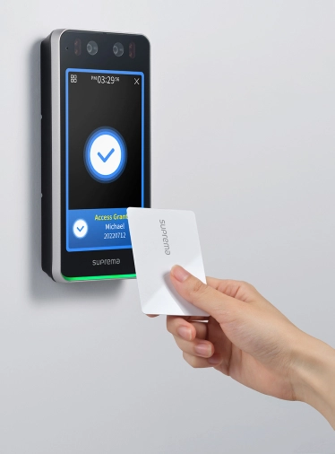 User presenting RFID access card to Suprema BioStar Air BioStation 3 reader for secure entry